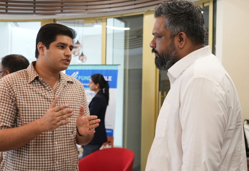 Founder conversation near a FundEnable banner